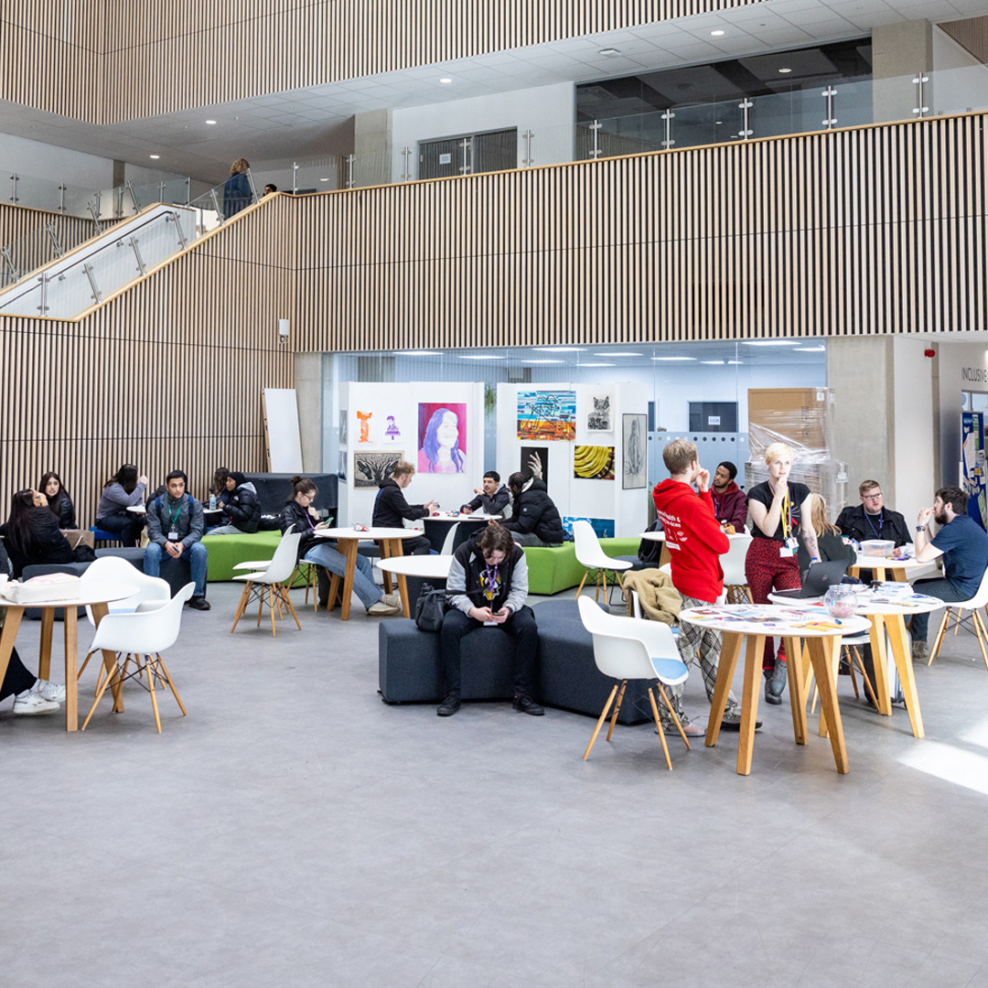 atrium of Richmond upon thames college with students in