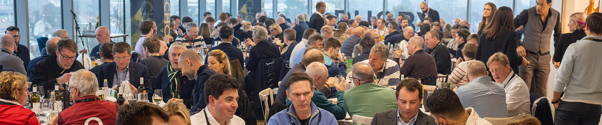 Six Nations Rugby event at The View Restaurant with Gaucho. The restaurant is full with people eating, drinking and talking around large round tables. 