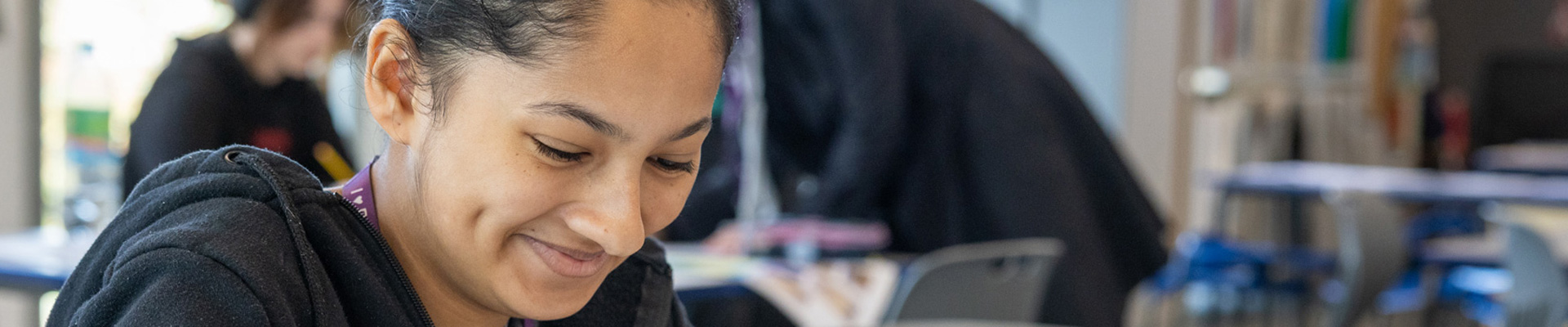 female student head down and smiling