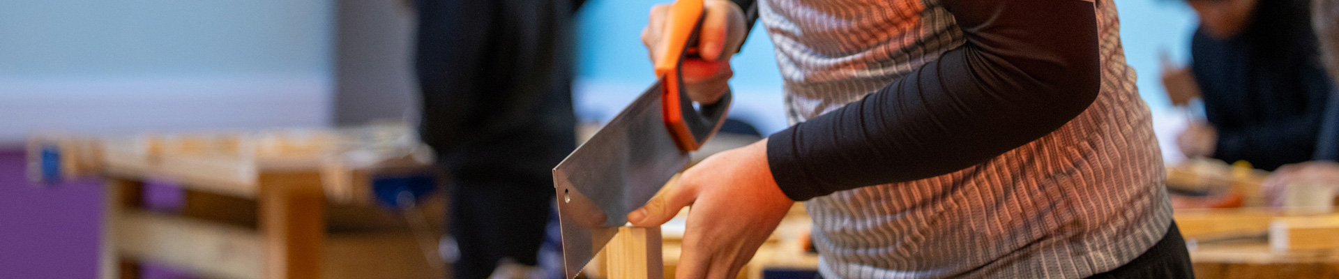 student using a saw