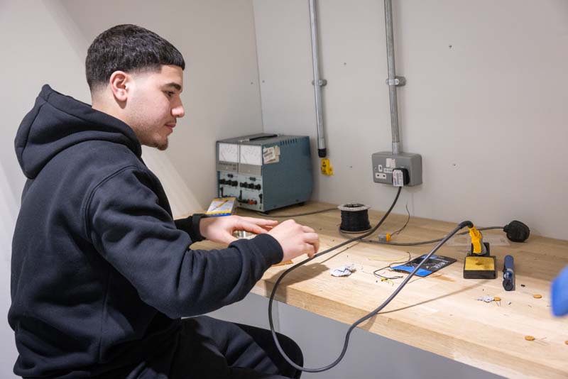 Electrical installation male student soldering