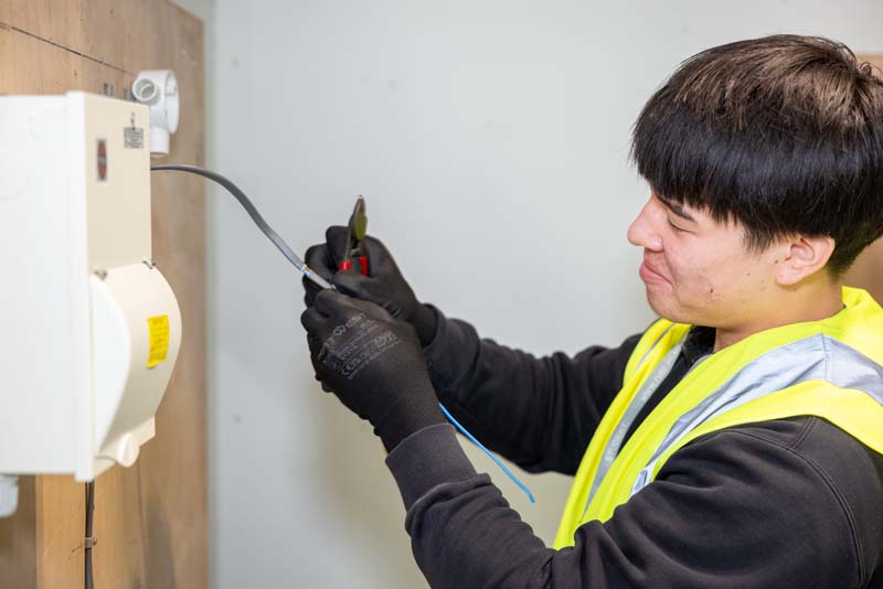 Electrical installation male student with pliers