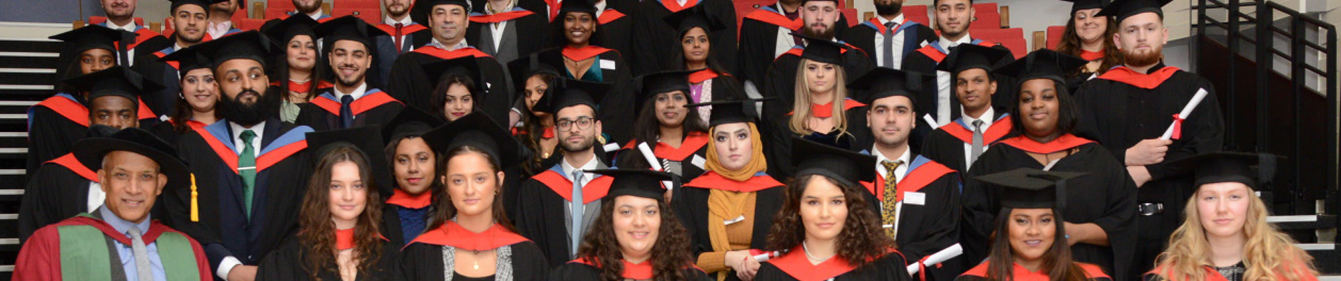 lots of students at graduation in hat and gown
