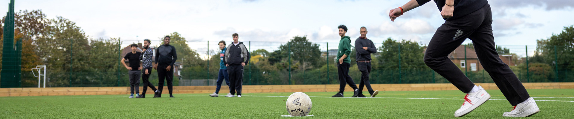 students playing football on sports field