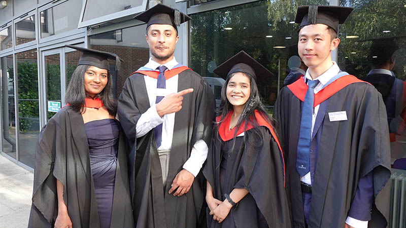 HND Computing graduating students posing for a photo in their caps and gowns at the HE Graduation ceremony 2025.