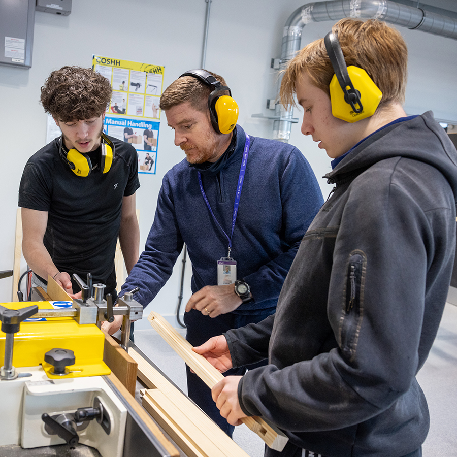 Richmond students being shown how to use one of the wood table saws.