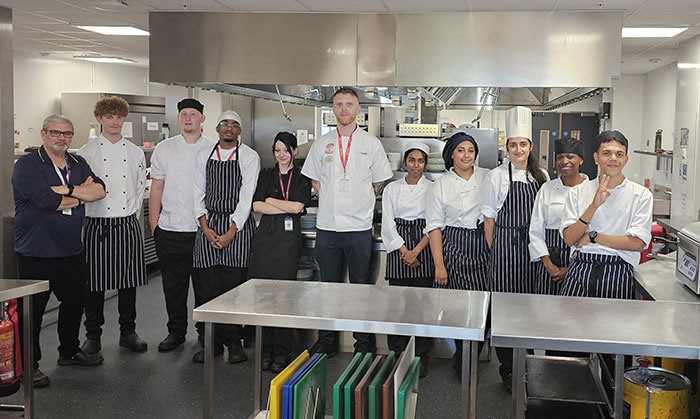 Professional Cookery & Hospitality students pictured as a group with Richmond upon Thames College alumnus during cheese workshop