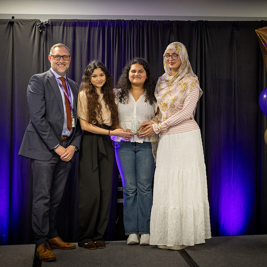 Female Richmond upon Thames College Art and Design students winning an award at the HRUC Skills Competition Awards Ceremony, presented by Kai Barnes, Assistant Principal.