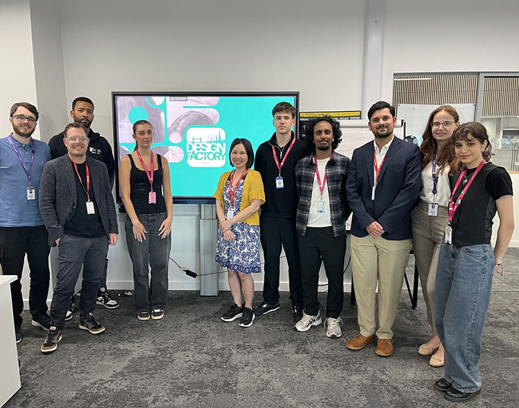 Business and Sports Students from Richmond upon Thames College standing together in front of a screen 