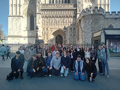 Large group of A-Level students posing outside Westminster Abbey in London