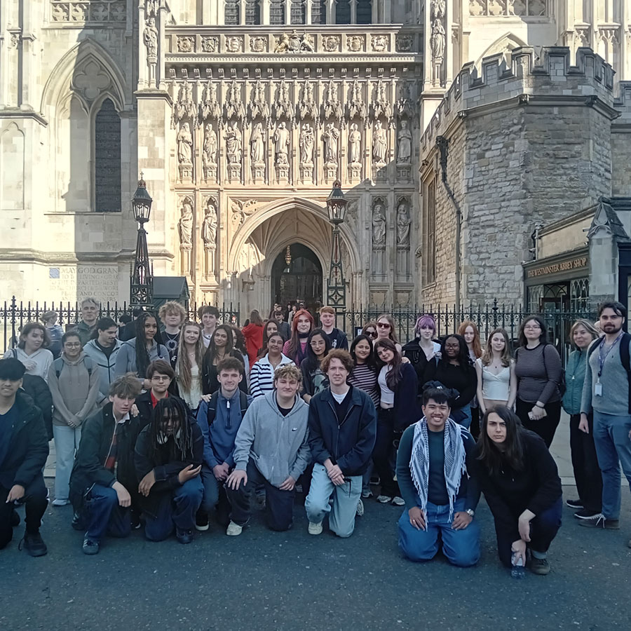 Large group of A-Level students posing outside Westminster Abbey in London