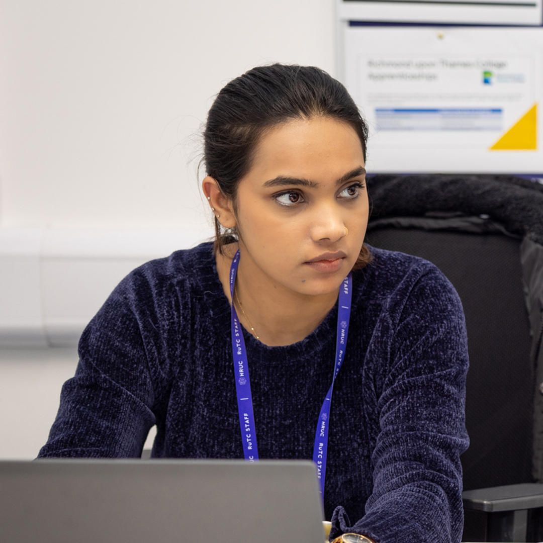 careers adviser at laptop helping a student